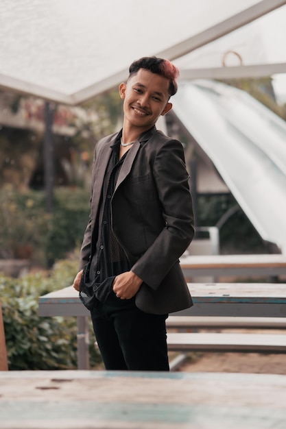 A teenage boy with blond hair posing very attractively and stylishly while wearing a blazer