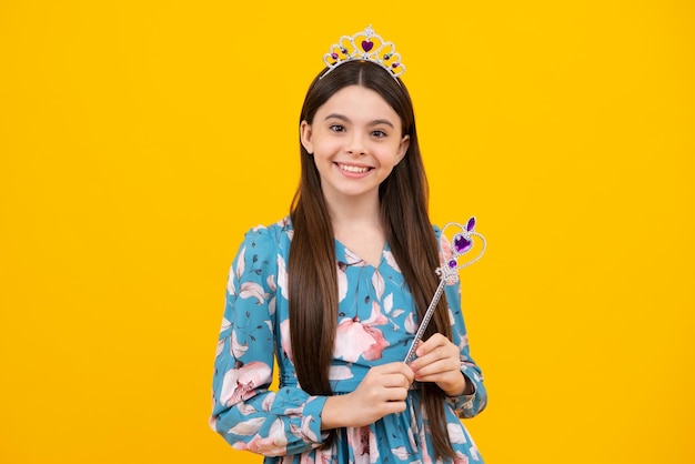 Teenage fairytale princess on yellow background Romantic wonderland story Little fairy girl with crown and magic wand putting spell