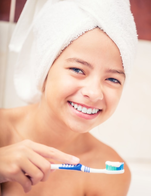 Teenage girl in the  bathroom with toothbrush. Dental hygiene.