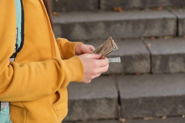 Teenage girl counts dollar bills