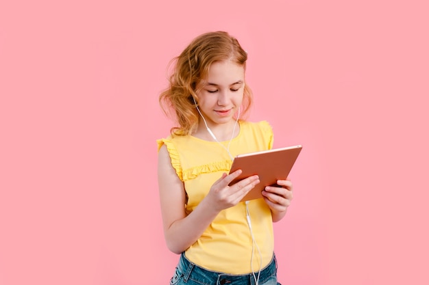 A teenage girl does her homework on tablet