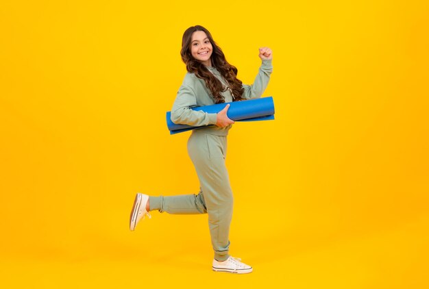 Teenage girl dressed in sports uniform posing in the studio Child in a posh stylish sports suit