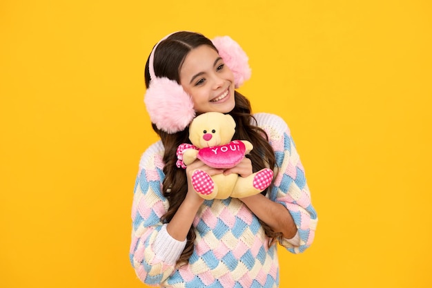 Teenage girl embracing toy childhood toys and kids cute teen\
girl cuddling favorite fluffy toy