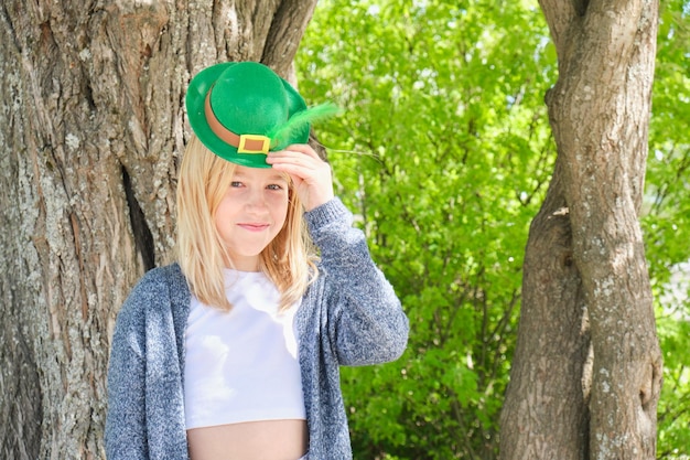 Teenage girl in a green leprechaun hat