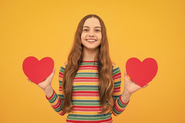 Teenage girl hold shape heart heartshape sign child holding a red heart love holiday valentine symbol