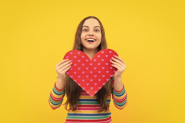 Teenage girl hold shape heart heartshape sign child holding a red heart love holiday valentine