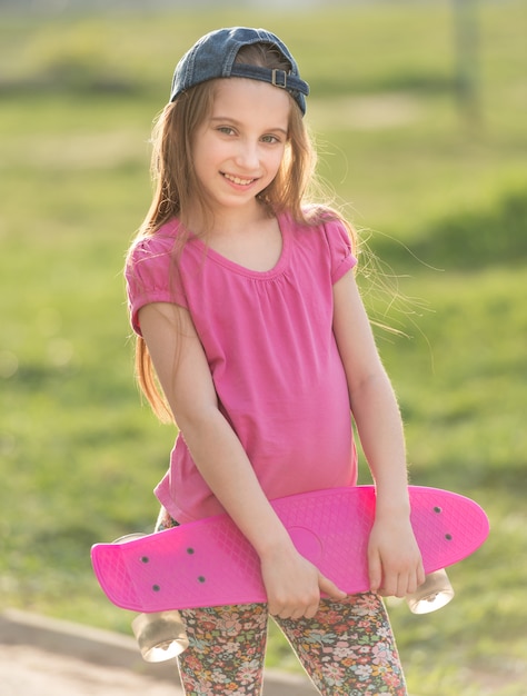 Teenage girl holding her pink board