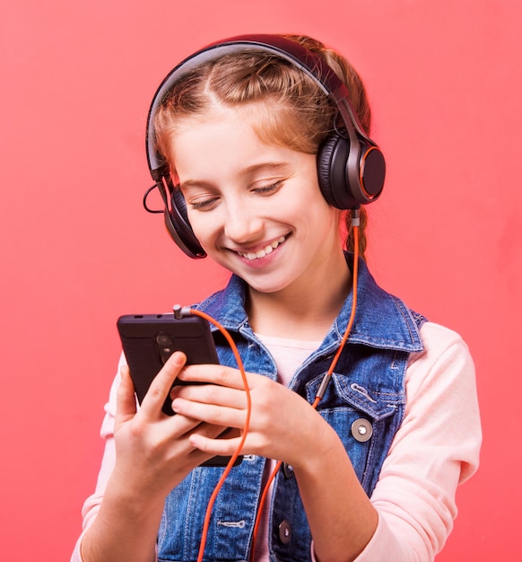 Teenage girl listening to music in big headphones