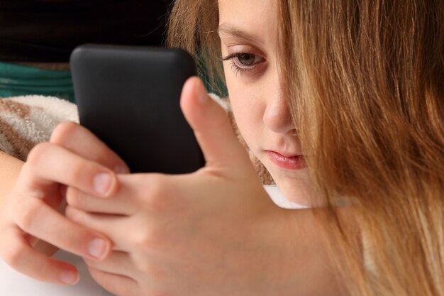 teenage girl looking at mobile phone
