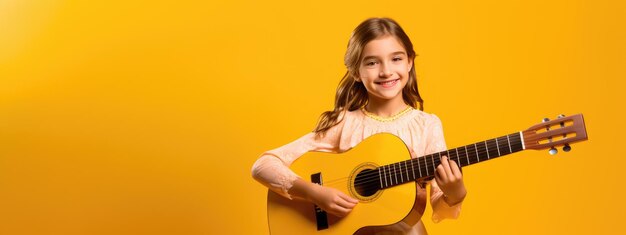 Teenage girl playing guitar on yellow background