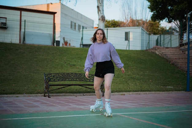 Teenage girl practicing rollerskating in the park