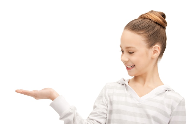 teenage girl showing something on the palm of her hand