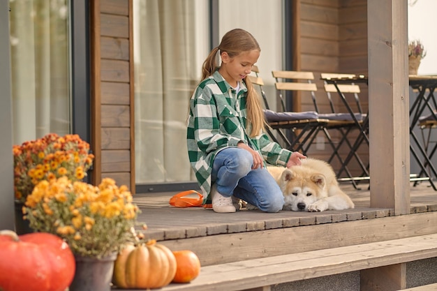 Teenage girl spending time with her canine outdoors