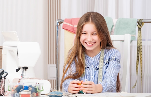 Teenage girl in tailor workshop