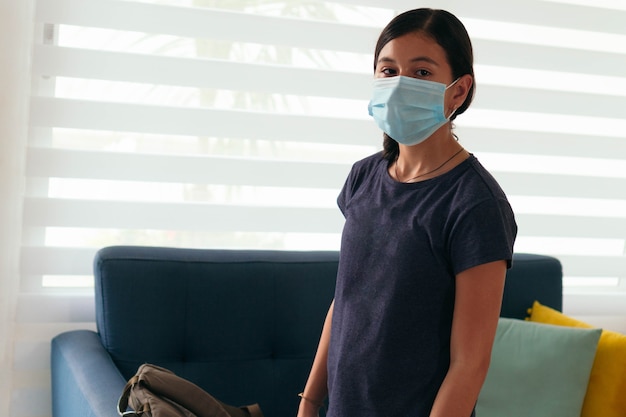 Teenage Girl Wearing Mask On First Day Back To School During Pandemic Shutdown