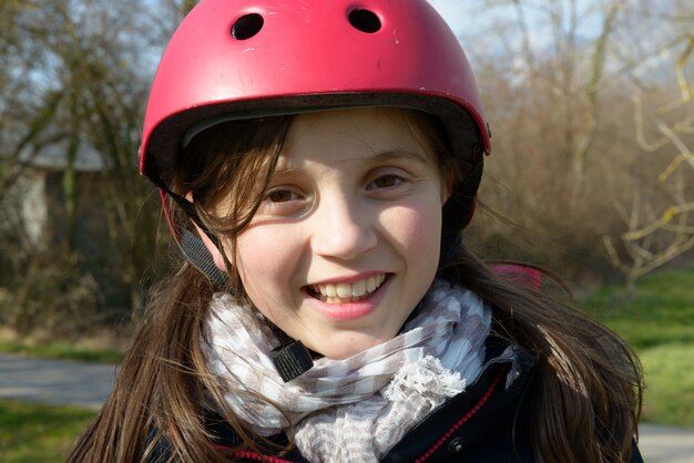 Teenage girl wearing a roller helmet.