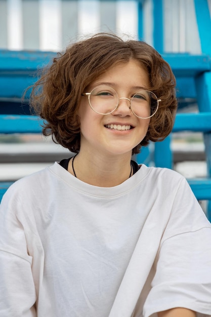 Teenage girl with curly hair in cool fashionable glasses