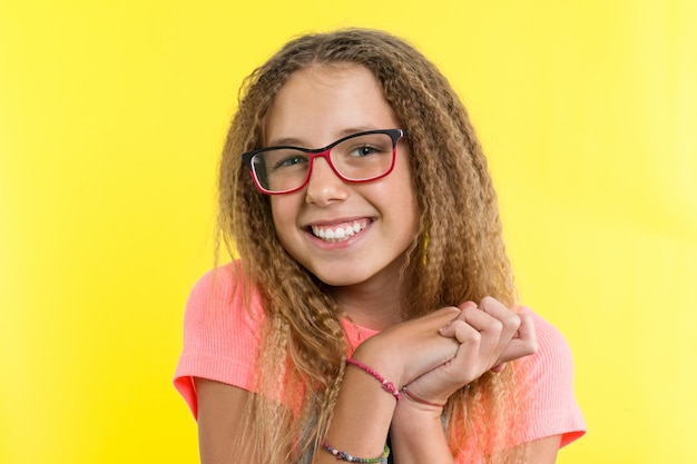 A teenage girl with glasses looks and smiling