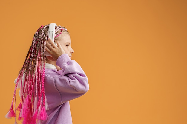 Photo teenage girl with headphones and bright dreadlocks