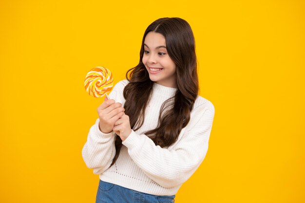 Teenage girl with lollipop child eating sugar lollipops kids sweets candy shop excited teenager girl happy face positive and smiling emotions of teenager girl