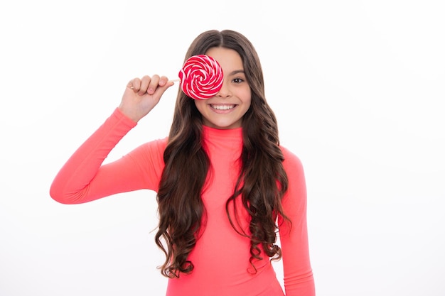 Teenage girl with lollipop child eating sugar lollipops kids sweets candy shop Excited teenager girl Happy girl face positive and smiling emotions