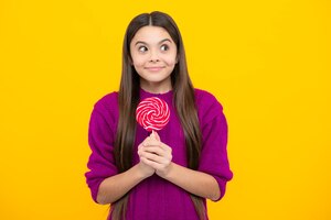 Teenage girl with lollipop child eating sugar lollipops kids sweets candy shop