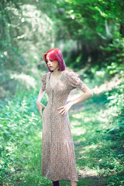 Teenage girl with red hair in summer dress