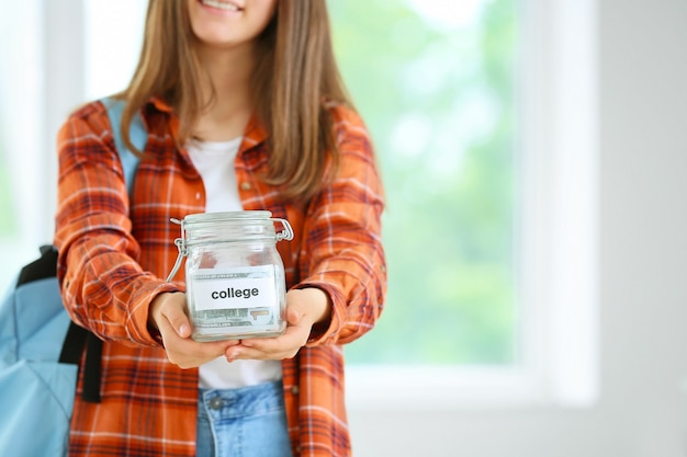 Teenage girl with savings for education in classroom