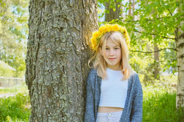 Teenage girl in a wreath of yellow dandelions