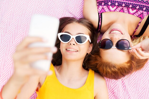  Premium Photo | Teenage girls in sunglasses taking selfie