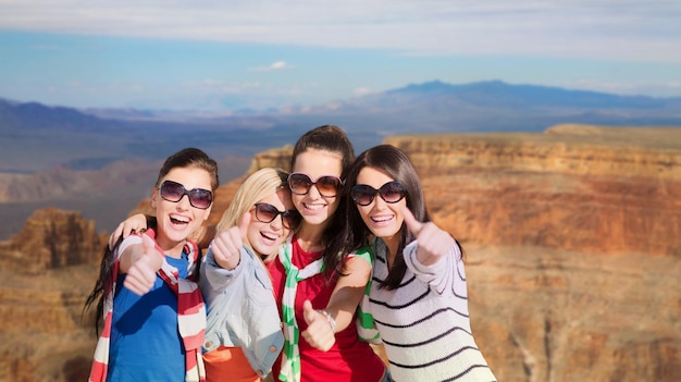 teenage girls or young women showing thumbs up