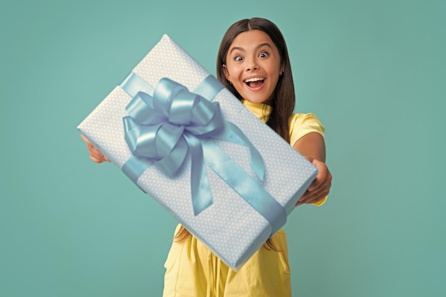 Teenage kid with present box teen girl giving birthday gift present greeting and gifting concept