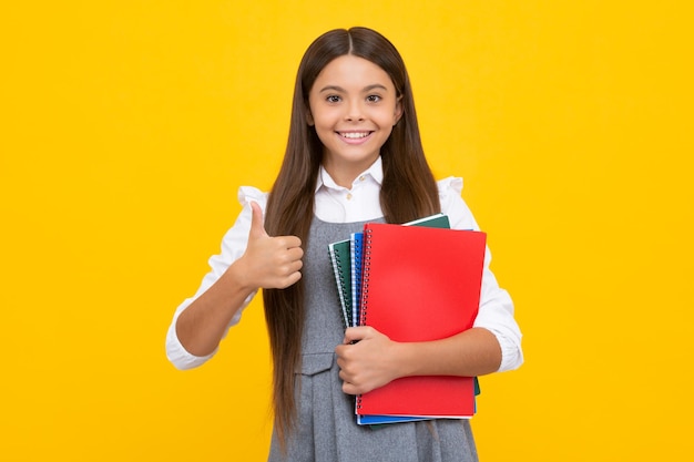 Teenage school girl with books Schoolgirl student Happy girl face positive and smiling emotions