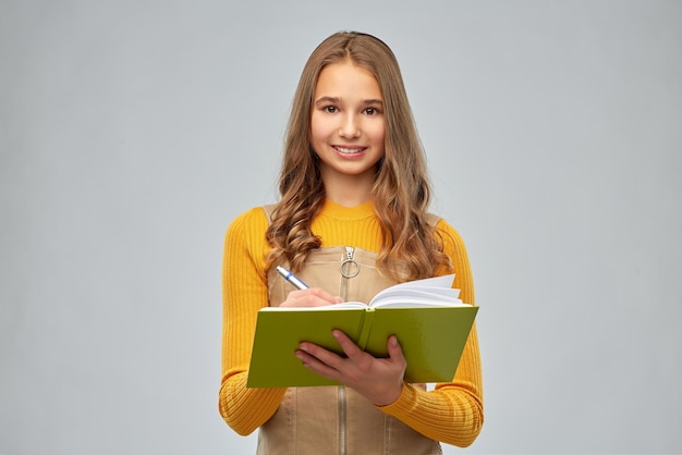 teenage student girl with notebook or diary