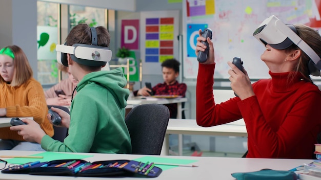 Teenage students with virtual reality glasses during a computer science class