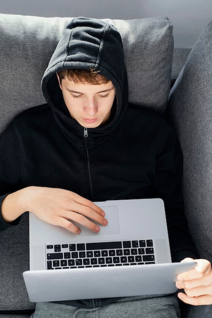 Teenager boy using laptop