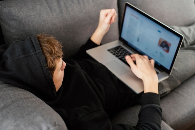 Teenager boy using laptop