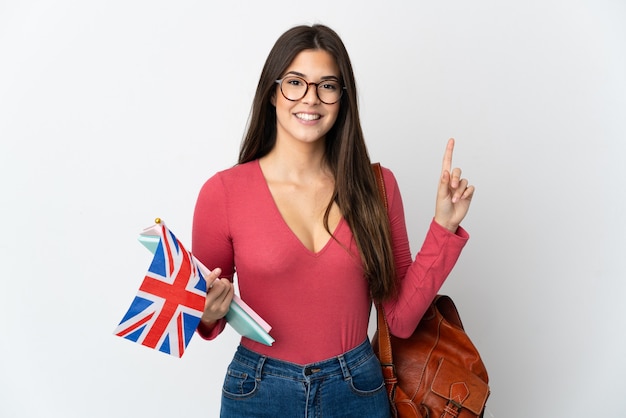 Teenager Brazilian girl holding an United Kingdom flag isolated on white wall pointing up a great idea