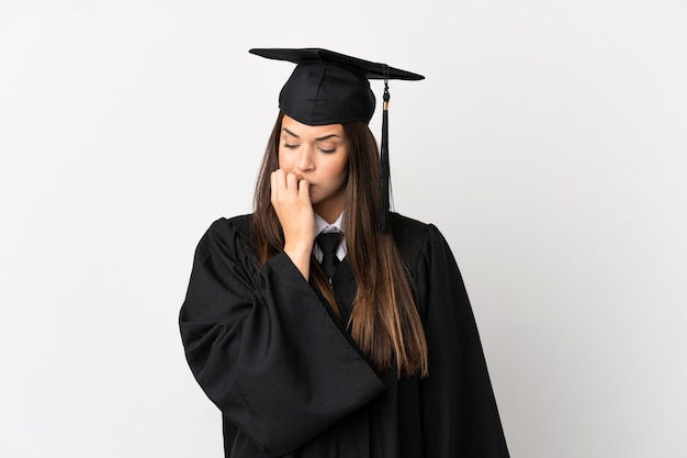 Teenager Brazilian university graduate over isolated white background having doubts