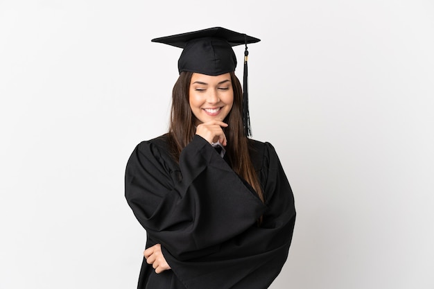 Photo teenager brazilian university graduate over isolated white background looking to the side and smiling