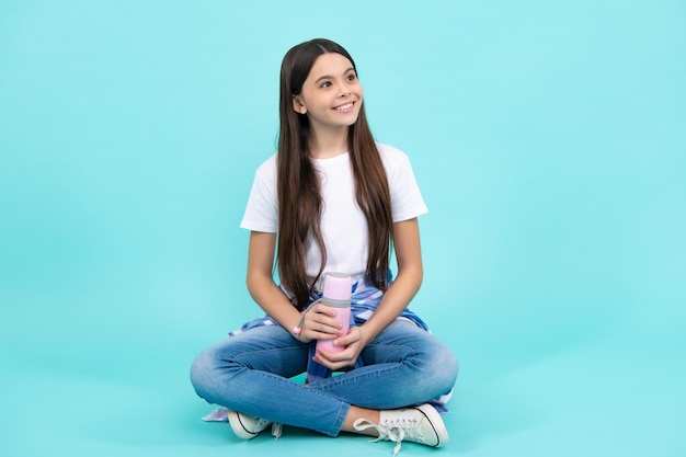 Teenager in casual wear hold water bottle Hipster teen Happy teenager positive and smiling emotions of teen girl