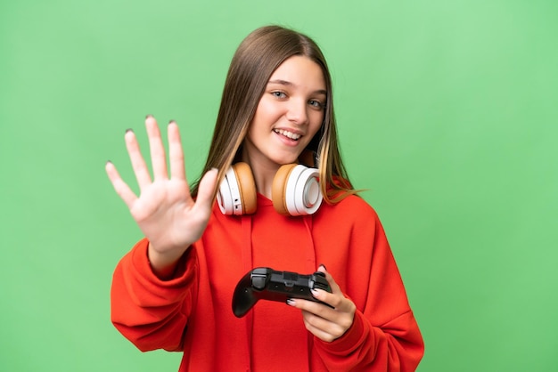 Photo teenager caucasian girl playing with a video game controller over isolated background