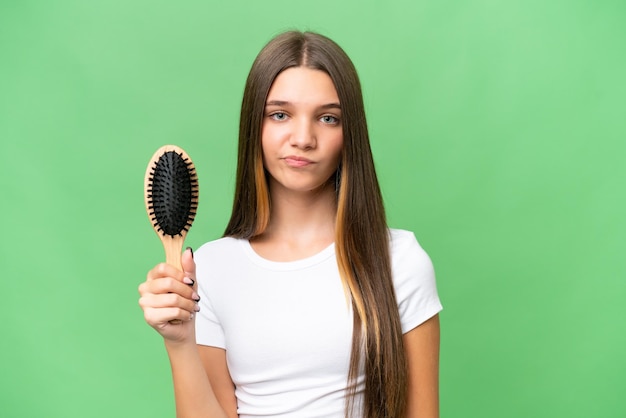 Teenager caucasian girl with hair comb over isolated background with sad expression