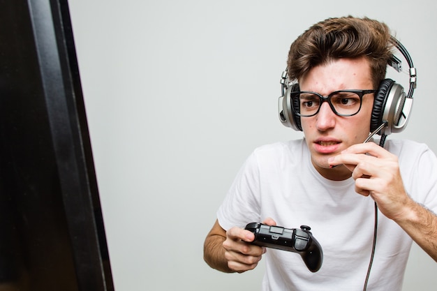 Teenager caucasian man playing computer games