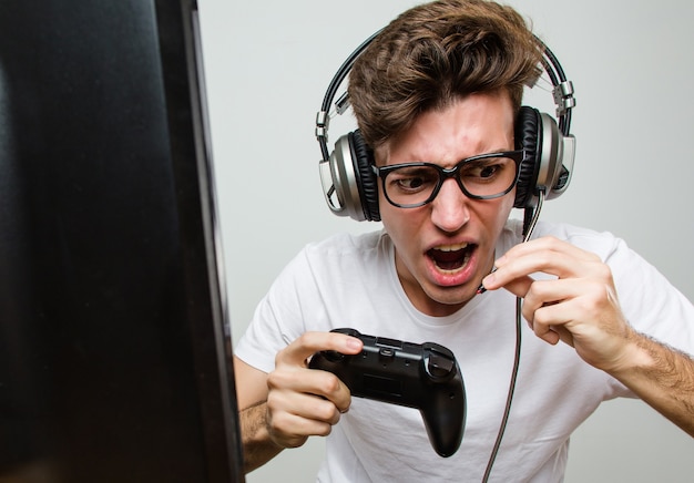 Teenager caucasian man playing computer games