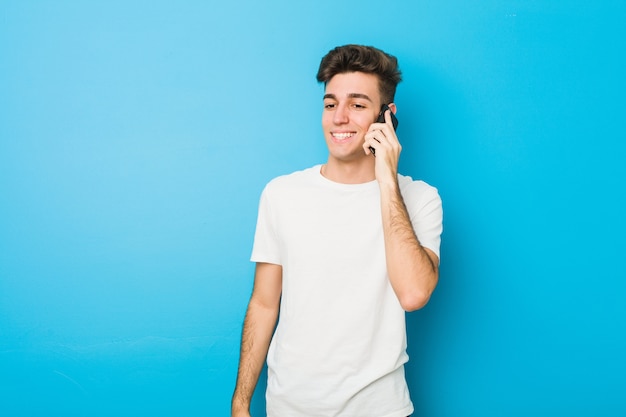 Teenager caucasian man talking on the phone