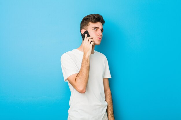 Uomo caucasico dell'adolescente che parla sul telefono