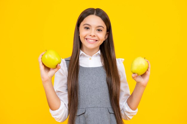 Teenager child girl biting tasty green apple