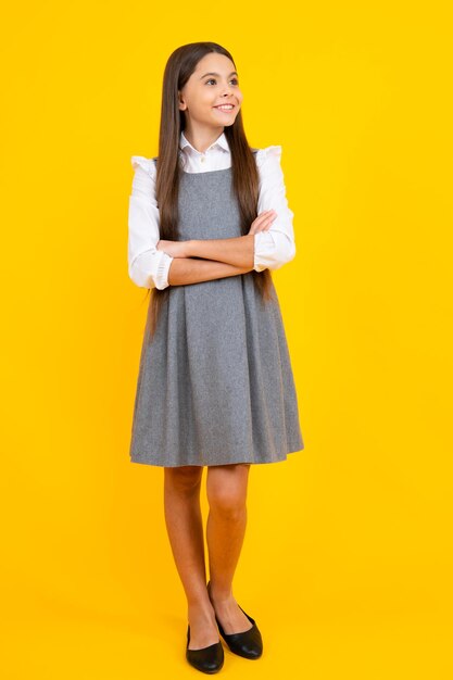 Teenager child girl casual clothes posing isolated on yellow background in studio Kids lifestyle concept