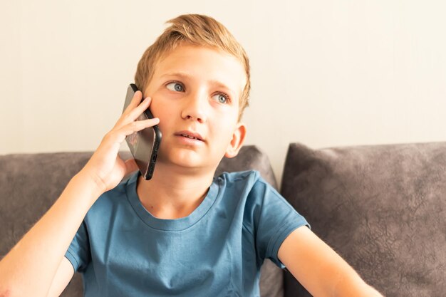 A teenager a child is talking on a mobile phone